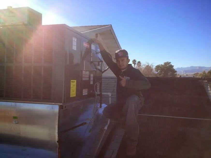 HVAC technician performing HVAC Inspection on a rooftop unit in Cumru